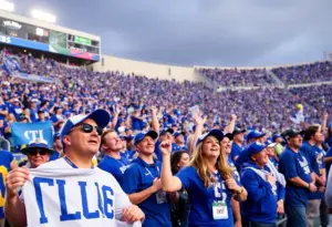 Crowd cheering at college football game with blue shirts