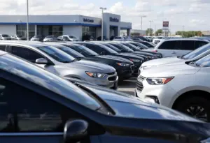 Wide view of Everest Motors Inc. used car dealership with various models on display.