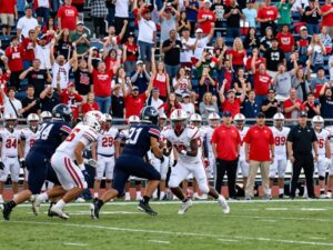 High school football players in action during a game in Houston