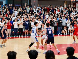 Players on a high school basketball court during a championship game