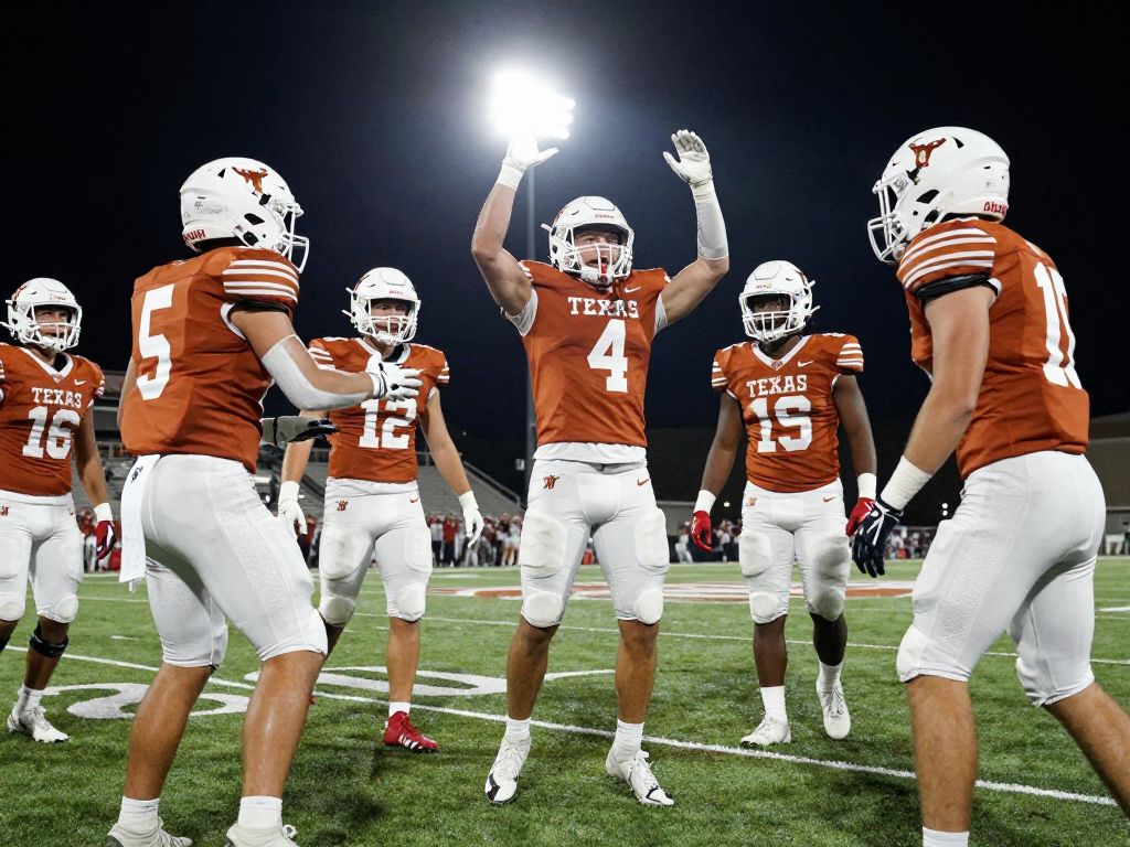 High school football players celebrating victory in Texas stadium.