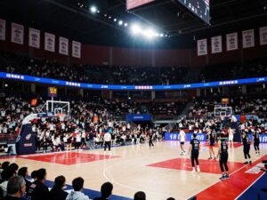Basketball arena with cheering fans and celebration banners