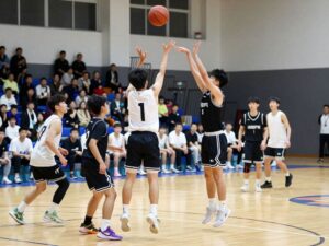 Exciting scene of Burbank Bulldogs players making three-point shots during a basketball game.