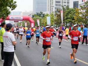 Runners participating in the Chevron Houston Marathon with city skyline in the background