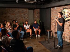 Chinedu Ogu performs at a comedy show in Houston.
