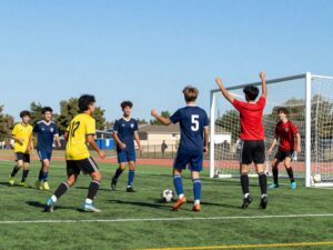 High school soccer players celebrating a goal during a match