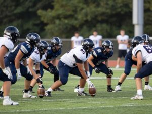 Dallas high school football players showcasing teamwork on the field