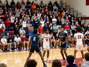 Players from South Grand Prairie and Sam Houston competing in a high school basketball game