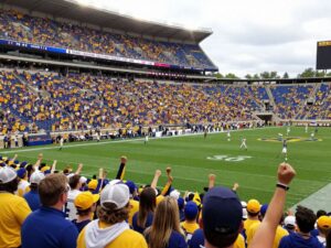 Crowd at a Houston Cougars football game celebrating a victory.