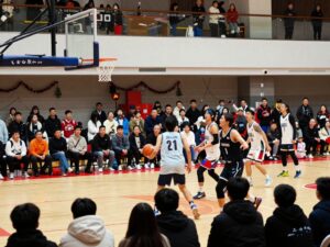 Community members enjoying the Houston County Christmas Basketball Tournament, showcasing local youth athletes competing.