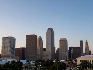 Houston skyline at dusk with Amber Alert message in the clouds.