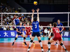 Action shot of a volleyball game featuring players in motion.