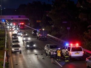 Night scene of a freeway accident with emergency vehicles