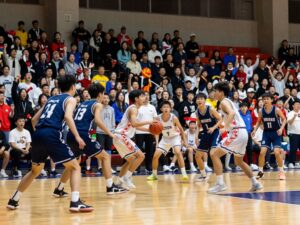 Action shot of Lee County Trojans and Houston County Bears playing basketball
