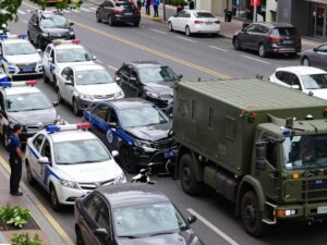 Police vehicles surrounding a military-style truck at a multi-vehicle accident scene in Houston.