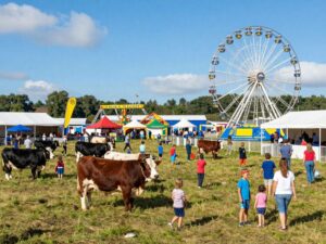 Families enjoying the Montgomery County Fair with rides and animals