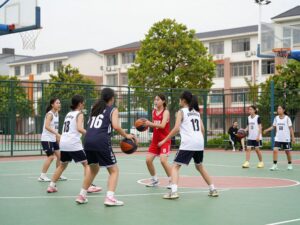 Young girls playing basketball in a community gym