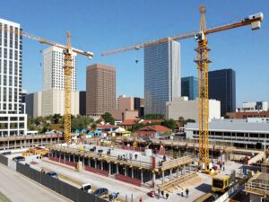 Construction site in Houston with cranes and workers