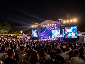 Crowd enjoying a live concert at a sunset amphitheater