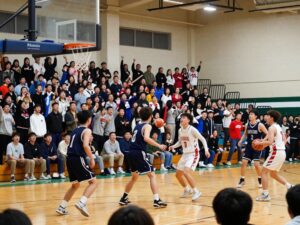 High school basketball game between Brennan and Judson with players in action.