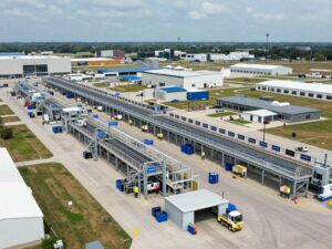 Workers in a Texas sign manufacturing facility amidst AI infrastructure boom.