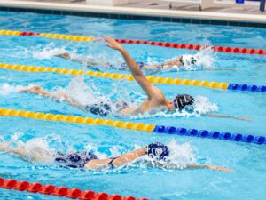University of Houston swimming athletes competing in a pool