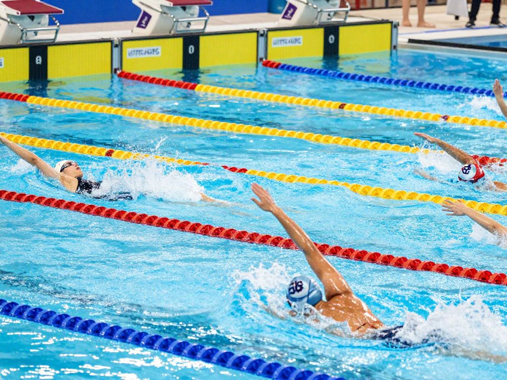 The University of Texas Women's Swimming team competing in a race