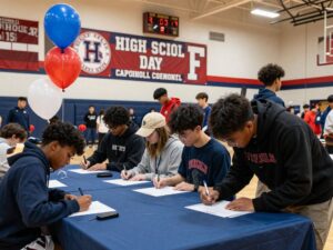 Athletes celebrating at Aldine Davis High School signing day
