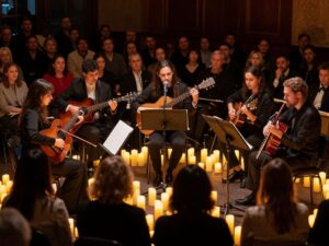 A candlelit concert atmosphere with musicians performing live music.