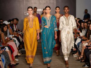 Models showcasing traditional attire at the Hispanic Alumni Fashion Show in Houston