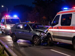 Scene of a car accident on the freeway with emergency responders.