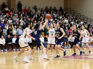 Kinkaid girls basketball team celebrating their championship victory in a packed gym.
