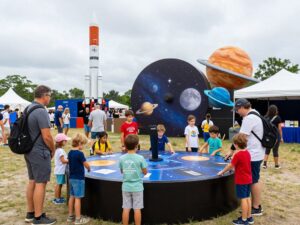Families exploring Space Center Houston during the Moon 2 Mars Festival