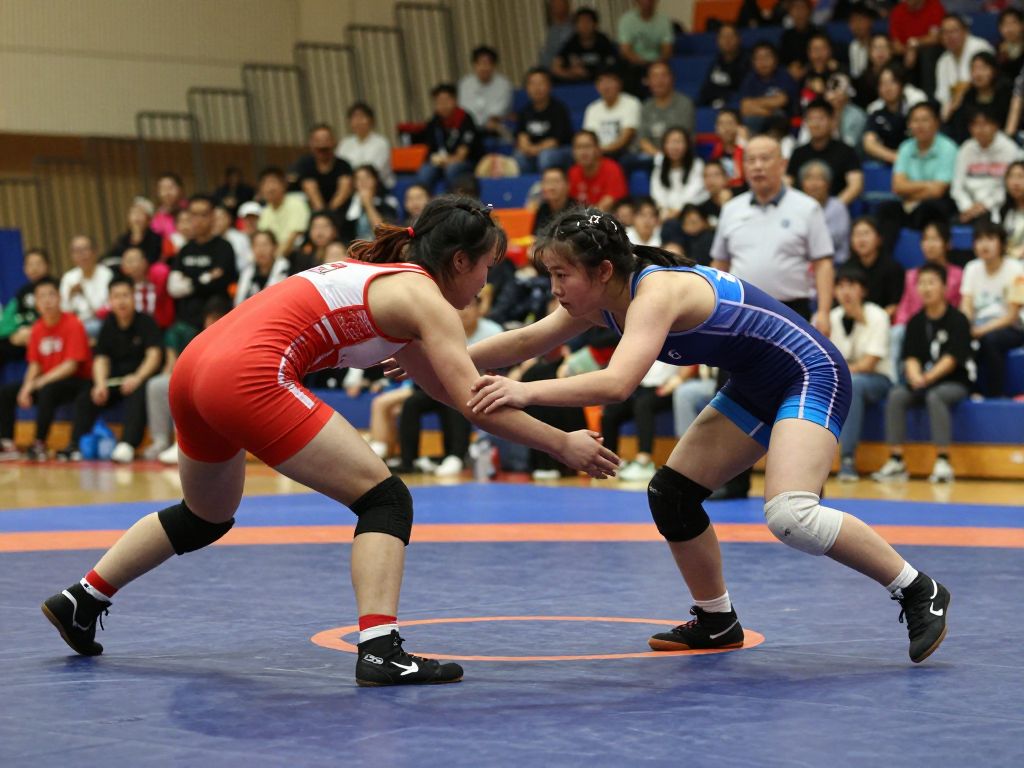 Female high school wrestlers competing at the Texas Girls State Wrestling Finals in Cypress.