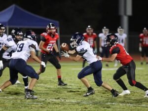 High school football players in action during a game in Texas.