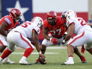 American football players showcasing high school talents during a game.