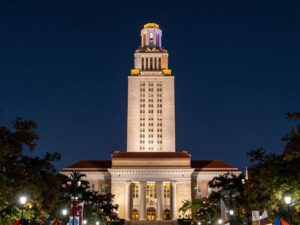 University of Texas Tower glowing at night, symbolizing pride and achievement.